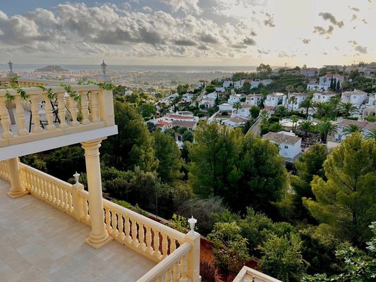 Terrace with balustrade overlooking coastal town and ocean